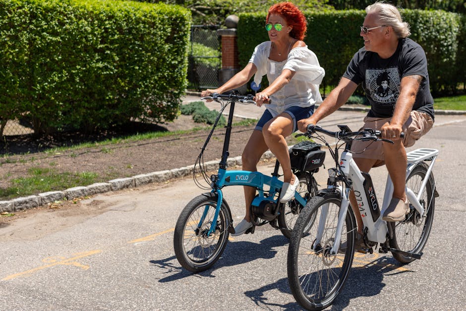 A couple rides electric bikes on a sunny day in Patchogue, NY.
